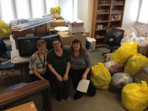 Episcopal Wichita Area Refugee Ministries staff with items donated by Hesston College students. Clothing, television, office supplies and even toiletries were given to local refugee families who arrived in the United States in the spring of 2013.