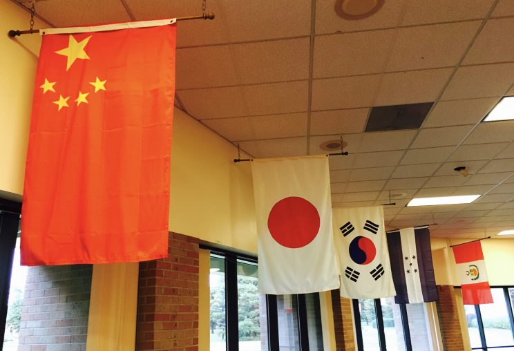 Flags representing each of the 17 countries of origin line the walls of the Hesston College cafeteria.