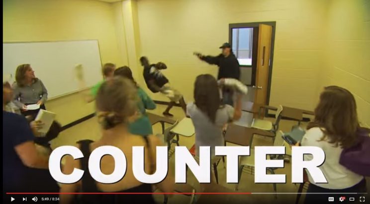 Auburn University Active Shooter Response Training video depicts the "Counter" option, where students try to distract a shooter by yelling and throwing things. (YouTube)