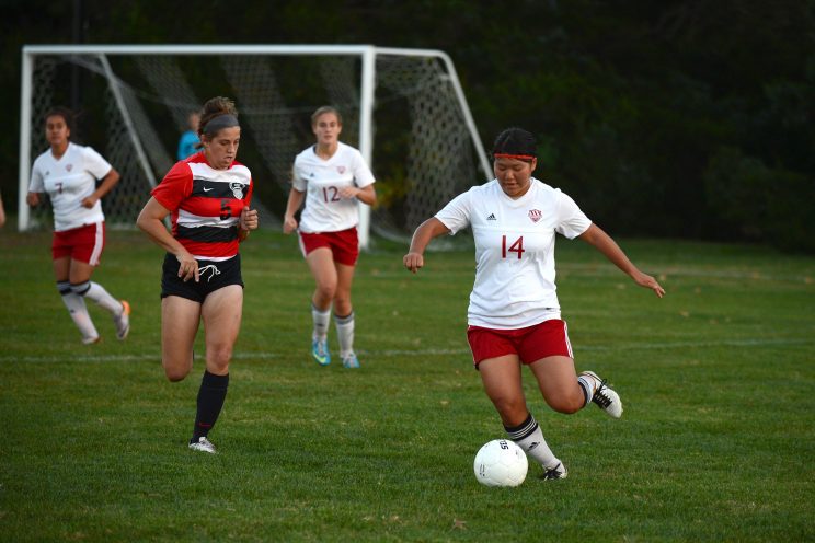 Miho Okuda chases down the ball against Coffeyville. Photo by Larry Bartel